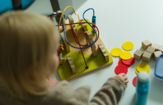 Lapsi leikkii neuvolassa pöydän ääressä