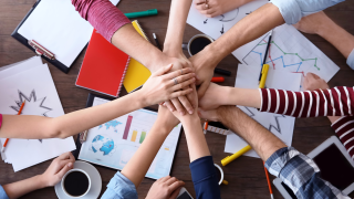 Lasten kädet pöydän päällä.